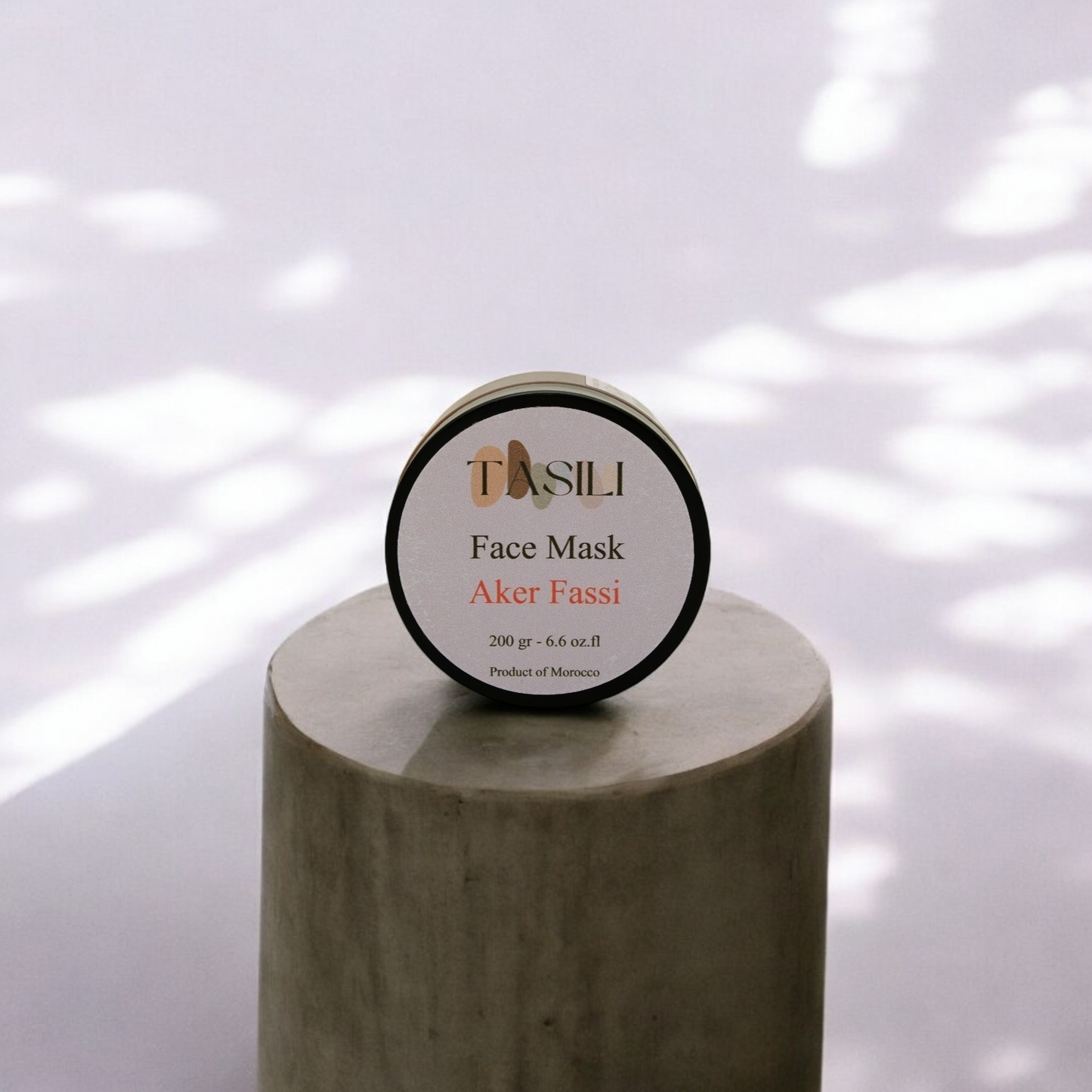 Akker Fassi Face Mask on circular wooden platform in natural lighting