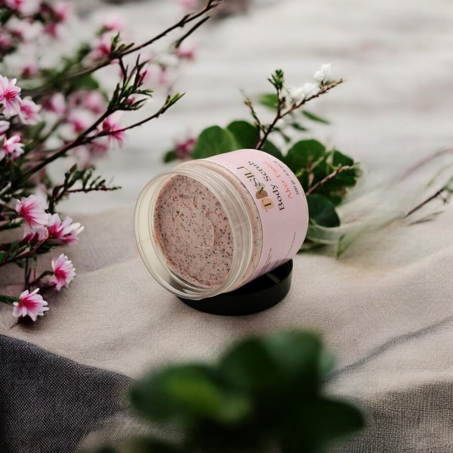 Akker Fassi Body Scrub on a towl surrounded by pink flowers