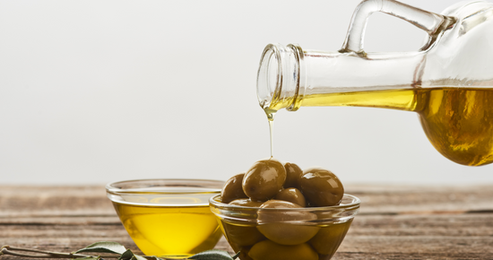 Olive oil and olives in bowl 