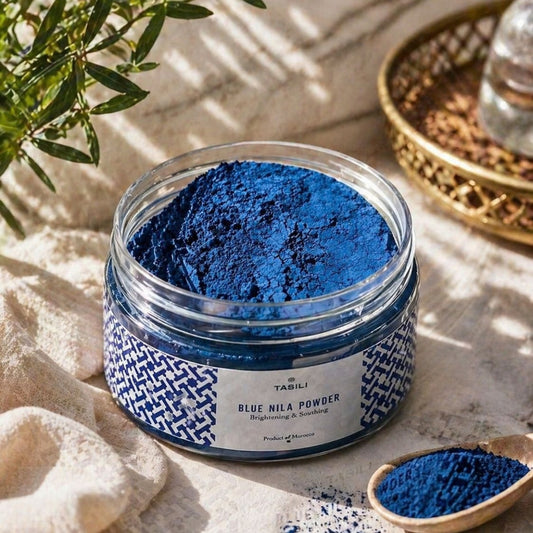 Blue Nila powder in a jar with a wooden scoop
